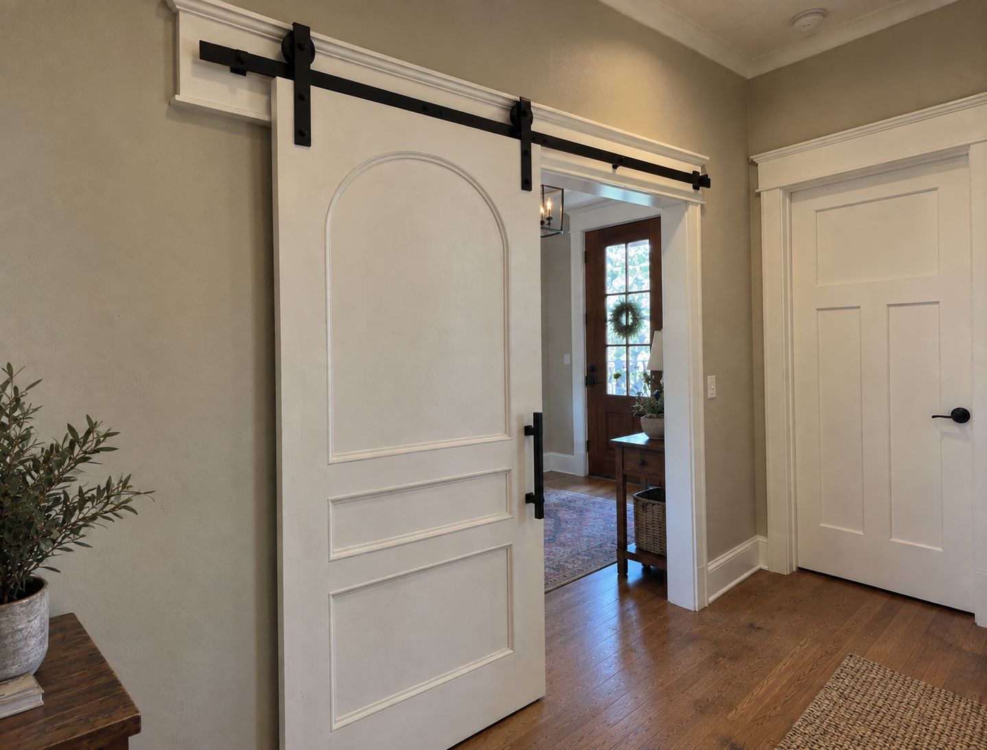 Custom arched barn door in entryway