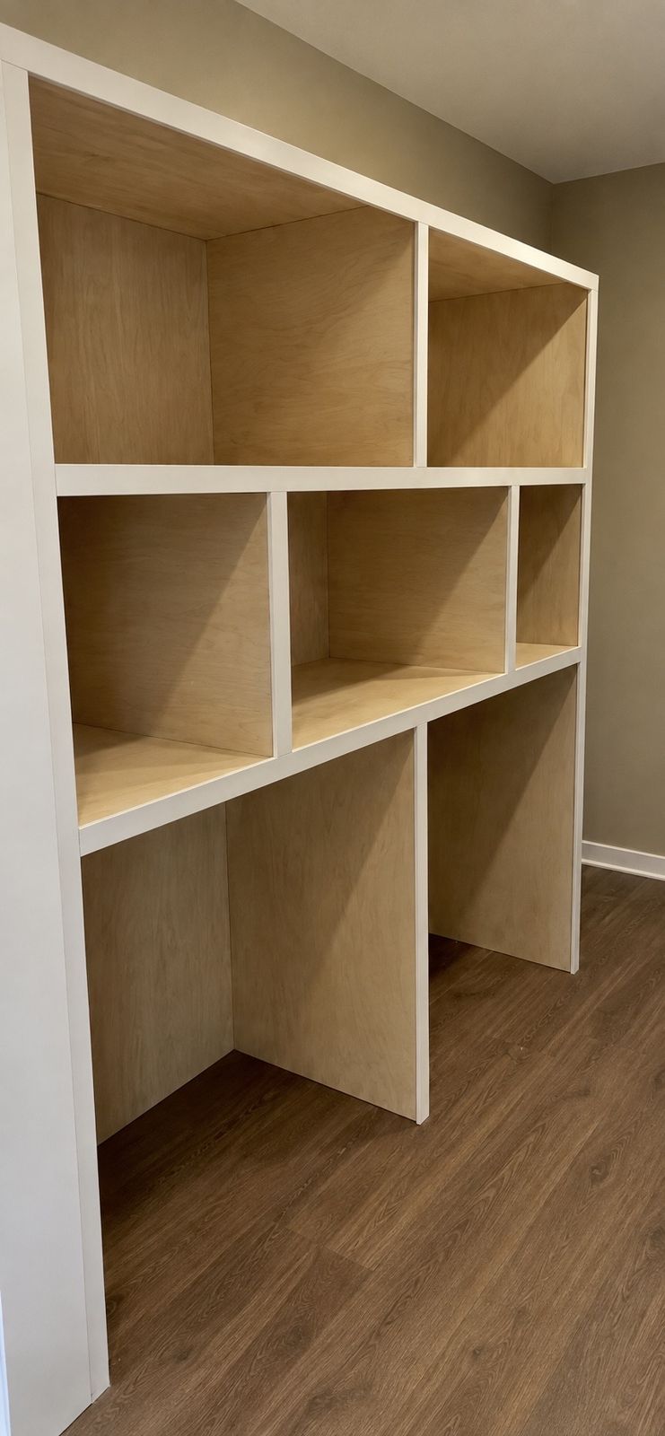 Custom built-in shelving with angled ceiling