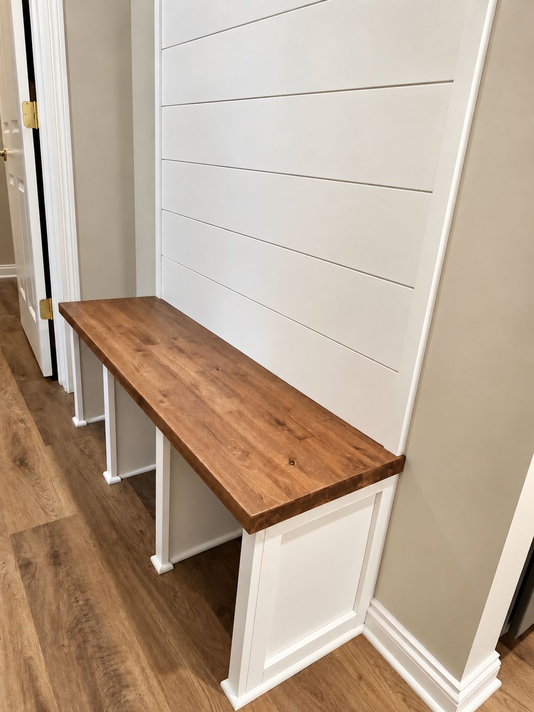 Built-in bench with shiplap wall
