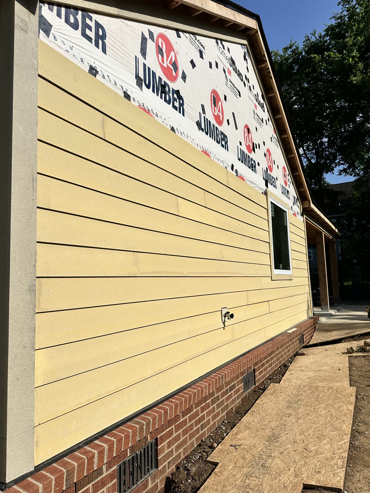 New lap siding installed over house wrap